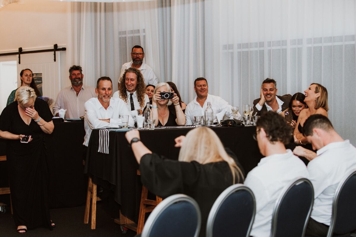 Whole table of guests in stitches